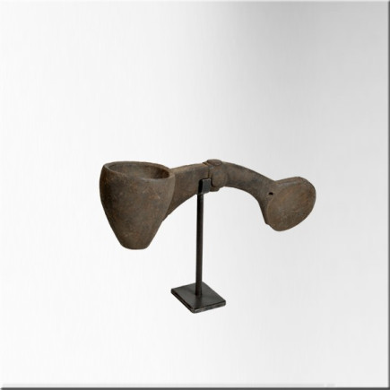 Small wooden milk ladle on iron base