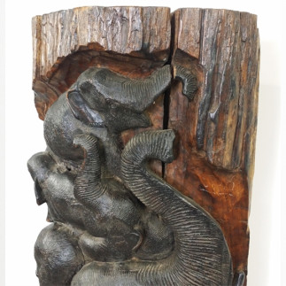 Famille d'éléphants sculptée sur un tronc