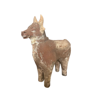 An impressive hand-sculpted terracotta figure of a stylised bull India late 19th century